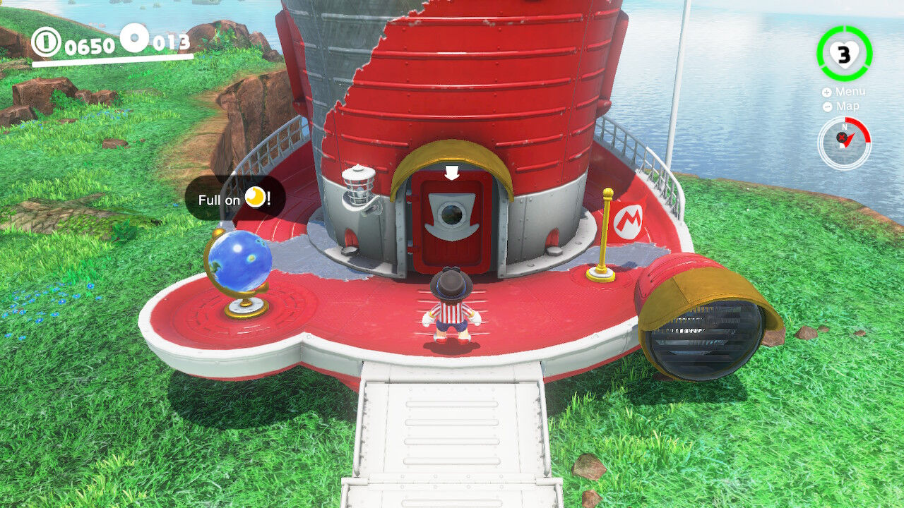 Mario standing in front of the red Odyssey ship on a grassy hill
